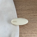 Détail d'une pince à cheveux ovale blanche en résine avec texte France Handmade sur toile - Ovale Étiquette Dorée-Blanc de Lait