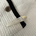 Close-up of teardrop acetate hair clip with marble pattern and gold metal plate - White
