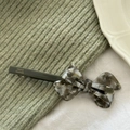 Detailed view of handmade acetate bow hair clip with gray marble texture and spring barrette - Gray