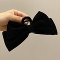 Classic black velvet bow hair claw clip for women shown in a high-quality hand-held view - Black