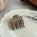 Close-up of matte coffee hair claw clip on vintage ceramic plate in a cozy setting - Long Tooth Shark Clip / Coffee