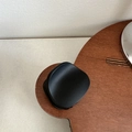 Detail of matte black claw clip on wooden surface showing sleek curved grip design - Round Trapezoid / Black