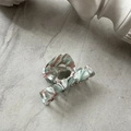 Close-up of marble pattern acetate hair claw clip with glossy green and pink texture - White Green Pink