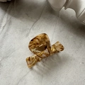 Detail of elegant amber tortoiseshell acetate hair claw clip with glossy texture - Amber