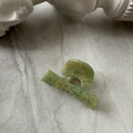 Detail of green and yellow marble pattern acetate hair claw clip with stone background - Green