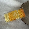 Detail view of high elasticity hair ties set in clear box with yellow tones - Yellow