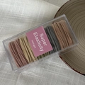 Detailed view of elastic hair bands set in Morandi tones inside a clear storage box - Light Morandi