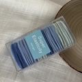 Detail of high elasticity hair ties set in Morandi blue and green within a transparent box - Blue