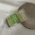 Set of high elasticity green gradient hair ties in a clear box on a ceramic plate - Green