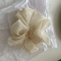 Detailed macro view of large cream white organza scrunchie with soft pleated texture - Milk White