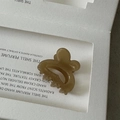 Macro shot of a brown translucent acetate rabbit hair claw clip with smooth resin finish - Transparent Coffee