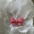 Close-up of a sweet pink double-layered bow hair clip with a glossy resin finish - Deep Pink Short Single Knot