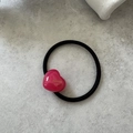 Detail of black elastic hair tie with a shiny pink heart pendant and French lettering - Rose Red