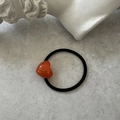 Detailed macro of a high-elastic black hair tie featuring a red acrylic heart pendant - Orange Red