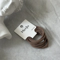 Close-up of brown elastic hair bands set on a white card display over stone texture - Dark Coffee