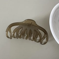 Detailed view of the large transparent amber resin shark clip with a durable metal spring - Green