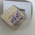 Close-up of two purple butterfly metal hair clips with matte finish on card - Purple