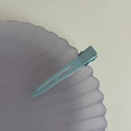 Macro view of light blue seamless metal hair clip with hollow stripe design for women - Blue