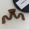 Macro detail of dark coffee wavy resin hair claw clip showing polished translucent finish - Wavy Coffee