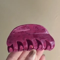 Close-up of cherry red acrylic hair claw clip with elegant marble texture detail - Dark Red