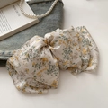 Detail of floral chiffon bow hair clip with yellow flower pattern and spring fastener - Midsummer Bloom Floral
