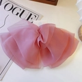 Detail of multi-layered lavender tulle butterfly hair clip on elegant white display card - Pink