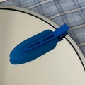 Macro shot of a matte blue seamless duckbill hair clip on a mirror with reflection - Blue