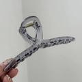 Dettaglio di una molletta per capelli da 14cm grigio fumo traslucido con molla in metallo oro - Blu Nebbia