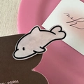 Close-up of a pink dolphin hair clip with a minimalist artistic illustration style - Black Border Dolphin