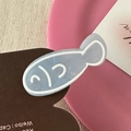 Detailed macro view of a cute blue fish hair clip made from translucent resin material - Light Blue Fish
