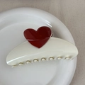 Detail view of heart-shaped cream and red hair claw clip on a white ceramic plate - Heart-shaped Color-blocked Fan - White