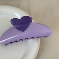 Detail view of a dual-tone purple heart hair claw clip on a white ceramic plate - Heart-shaped Color-blocked Fan - Purple
