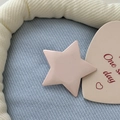 Close-up of a matte pink Y2K star-shaped hair clip on a soft blue knit background - Light Pink