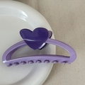 Detailed view of heart-shaped hair claw clip in purple contrast colors on a ceramic plate - Heart-shaped Color-blocked Clothes Hanger - Purple