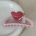 Close-up of a pink heart hair claw clip on a white plate with aesthetic background - Heart-shaped Color-blocked Clothes Hanger - Pink