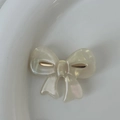 Elegant ivory acetate bow hair clip with pearlescent finish and gold accents - White