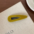 Close-up of mustard yellow velvet hair clip with matte black base on canvas background - Teardrop / Ginger Yellow