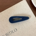 Close-up of a deep blue velvet-covered metal snap hair clip on a neutral linen surface - Teardrop / Dark Blue