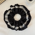 Detail view of oversized layered scrunchie with black white contrast and polka dot fabric - Black