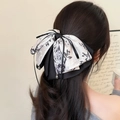 Elegant ink-style floral bow hair clip with crystal pendant worn on long wavy hair - Ink Bowknot Ponytail Clip