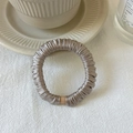 Satin champagne silk scrunchie on cream ceramic saucer with aesthetic background - Champagne