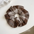 Detailed view of the brown and beige plaid fabric texture of the large scrunchie - Brown Hair Ring