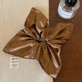 Detail of silk satin polka dot scrunchie with large bow on a rustic wooden background - Caramel Coffee Polka Dot