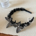 Detailed close-up of handmade black butterfly headband with shimmering rhinestones and beads - Black