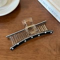 Macro detail of large resin hair claw clip with vintage polka dots and gold metal spring - Black Polka Dot