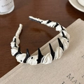 Detailed macro view of handmade headband with elegant pearls and polka dot fabric texture - Black And White Polka Dot Pearl Style / White