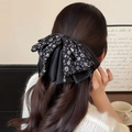 Floral bow hair claw clip with crystal pendants on long curly hair for autumn styling - Black and White Speckled