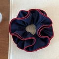 Detail view of navy blue scrunchie with red heart pattern and contrast edge stitching - Navy Blue