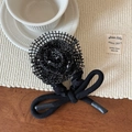 Detail of a handmade black mesh rose hair tie with layered lace and French bow design - Black