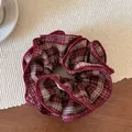 Macro shot of red plaid scrunchie with layered ruffles and delicate overlock edge - Red Plaid